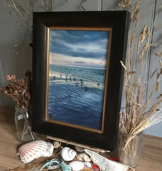 Framed oil painting of low tide at sunrise with seagulls by artist simon royer.