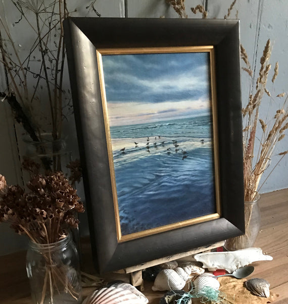 Framed oil painting of low tide at sunrise with seagulls by artist simon royer.